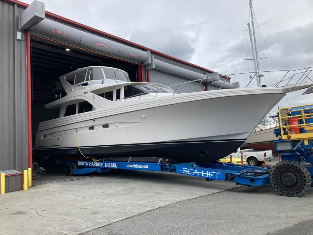 A boat is being loaded onto the trailer.